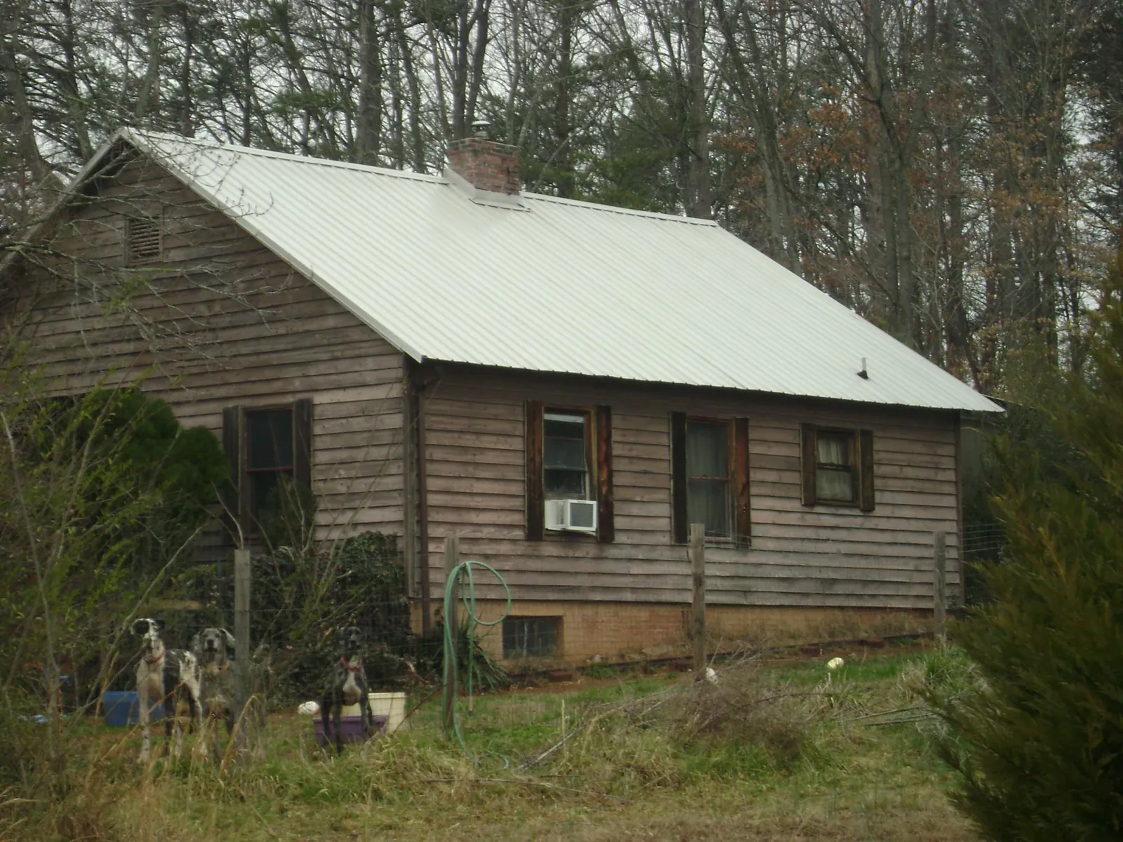 White metal roof on an old wood sided farmhouse, from a Metal Roof Installation job in El Monte